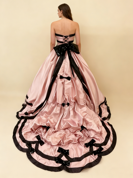 Pink satin ball gown model wearing back view 